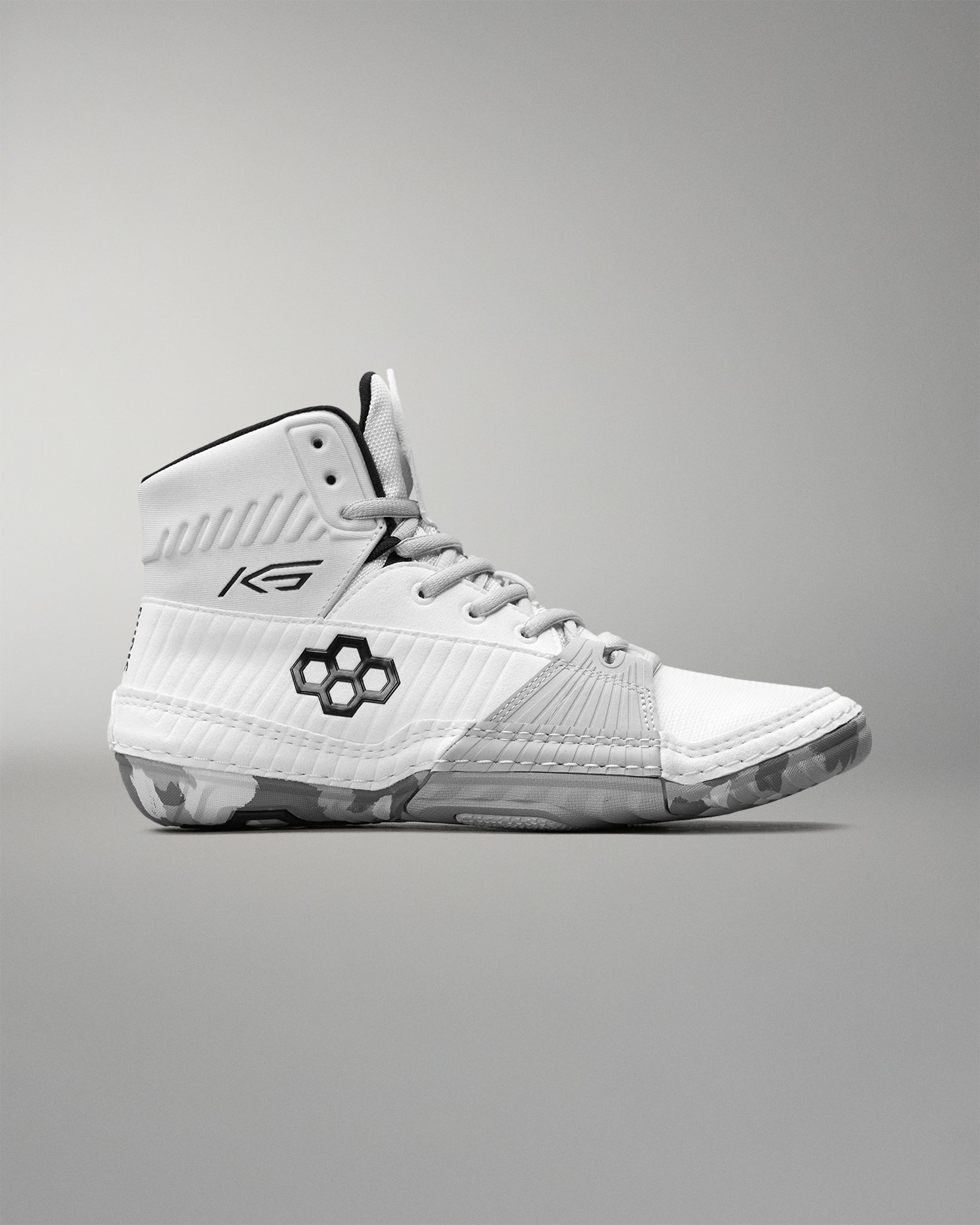 White wrestling shoe with black accents on a gray background
