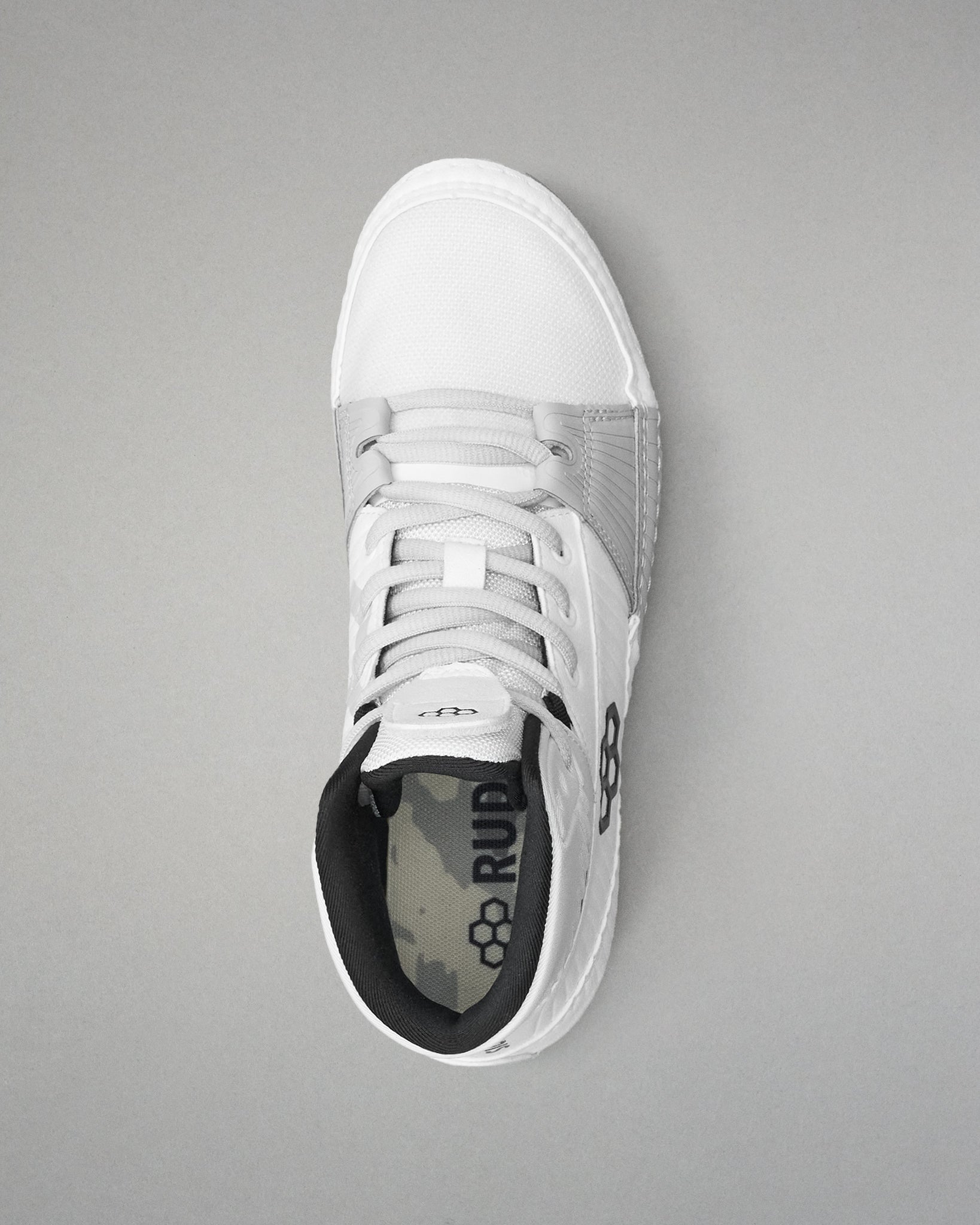 White wrestling shoe with black sole on a gray background