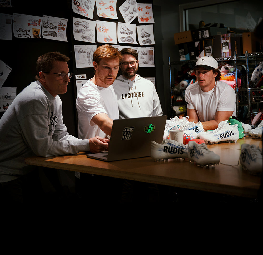 RUDIS product development meeting with Pat Kavanagh and Chris Kavanagh and the RUDIS design team reviewing custom lacrosse cleat concepts, prototypes, and performance footwear innovations.