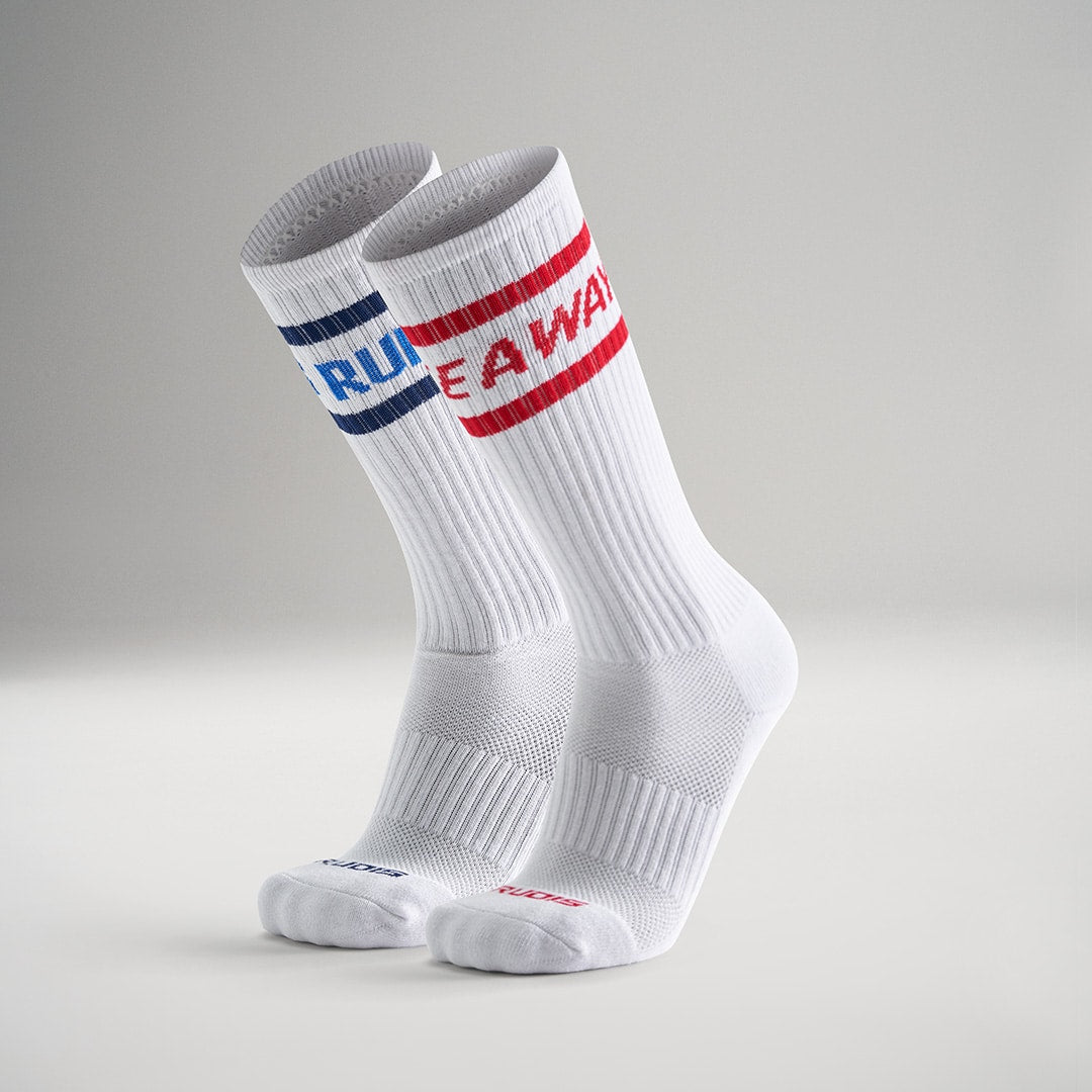 This image features a pair of white athletic socks with blue and red banding at the top labeled RUN and AWAY