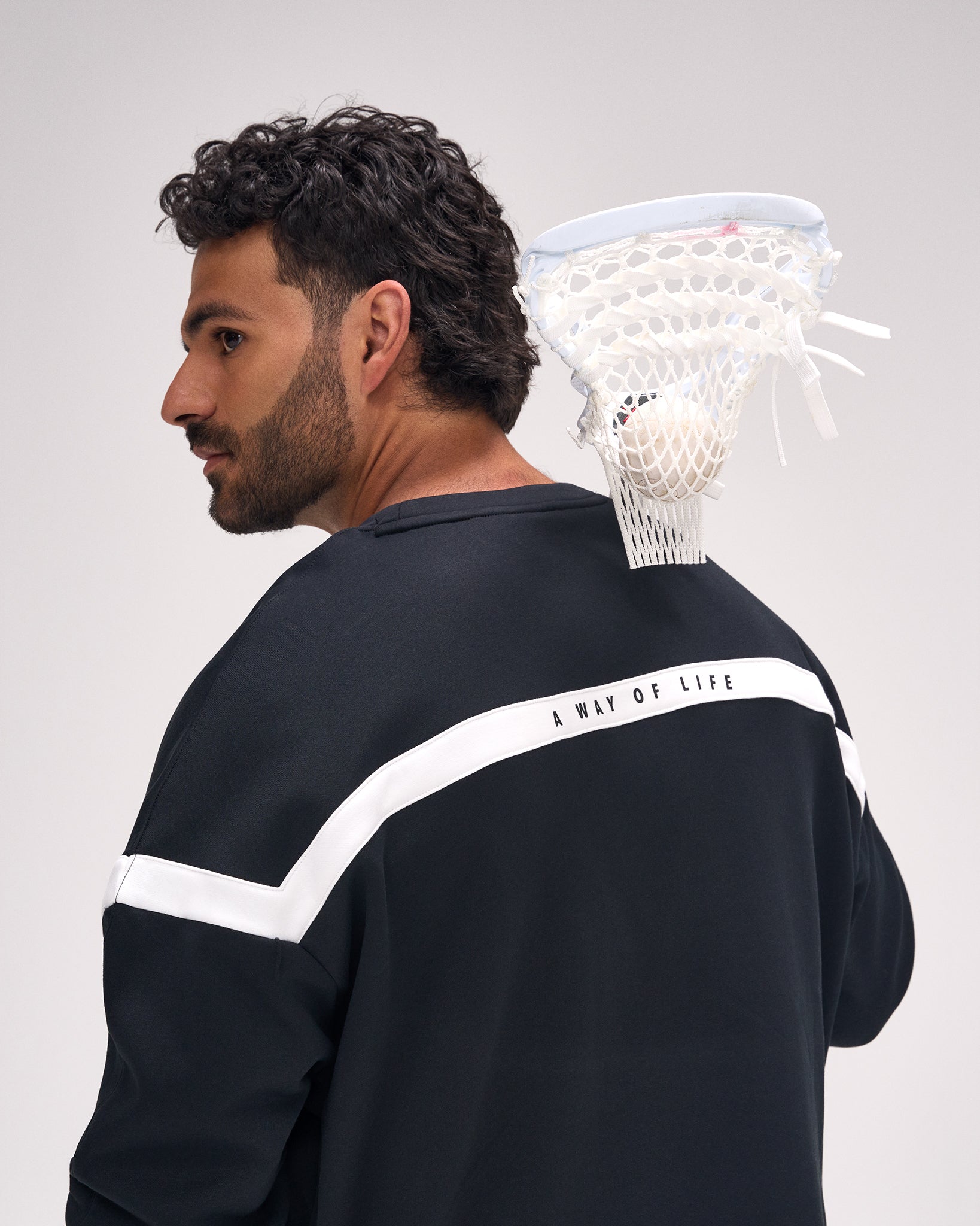 Rear view of the RUDIS Lacrosse Colorblock Crewneck in Blackout featuring the signature white back panel with "A Way of Life" branding and athletic colorblock design.
