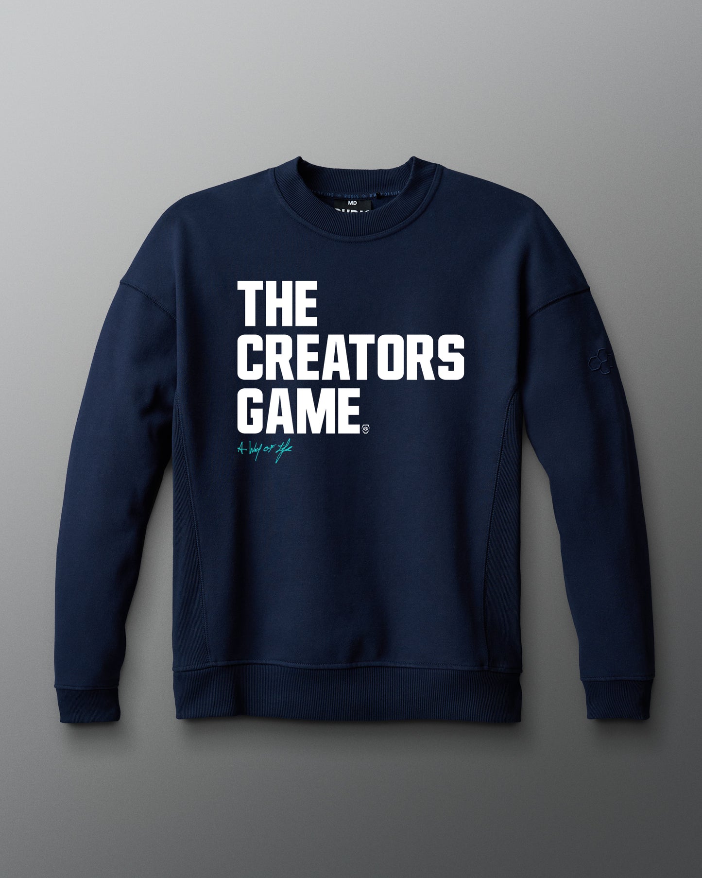 Navy blue sweatshirt with 'THE CREATORS GAME' text on a gray background
