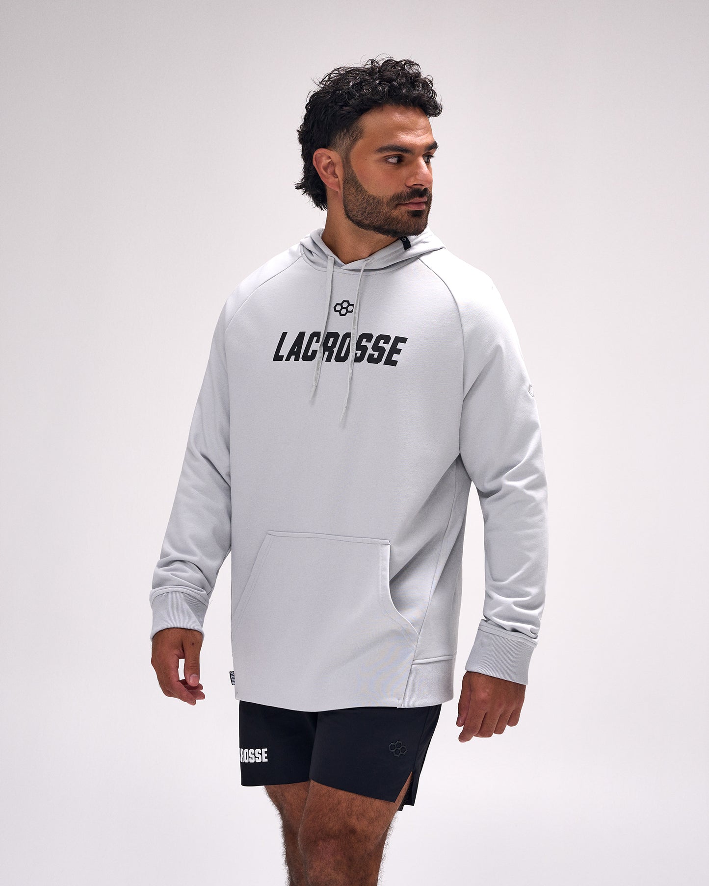 Male athlete wearing the RUDIS Lacrosse Elite Terry Hoodie in Lunar featuring a minimalist "Lacrosse" chest graphic, premium French terry fabric, and an athletic relaxed fit.