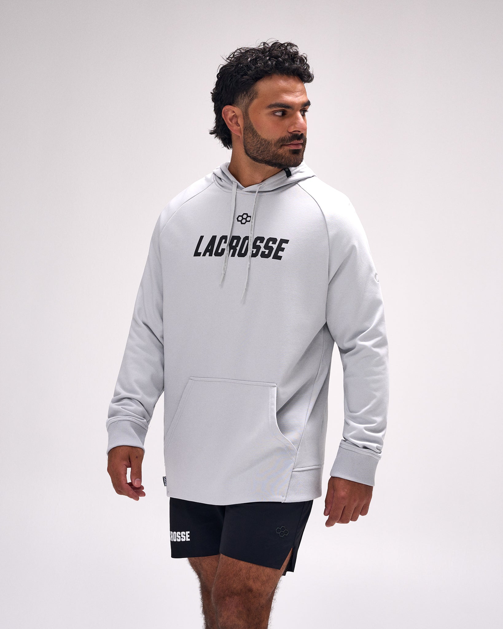 Male athlete wearing the RUDIS Lacrosse Elite Terry Hoodie in Lunar featuring a minimalist "Lacrosse" chest graphic, premium French terry fabric, and an athletic relaxed fit.