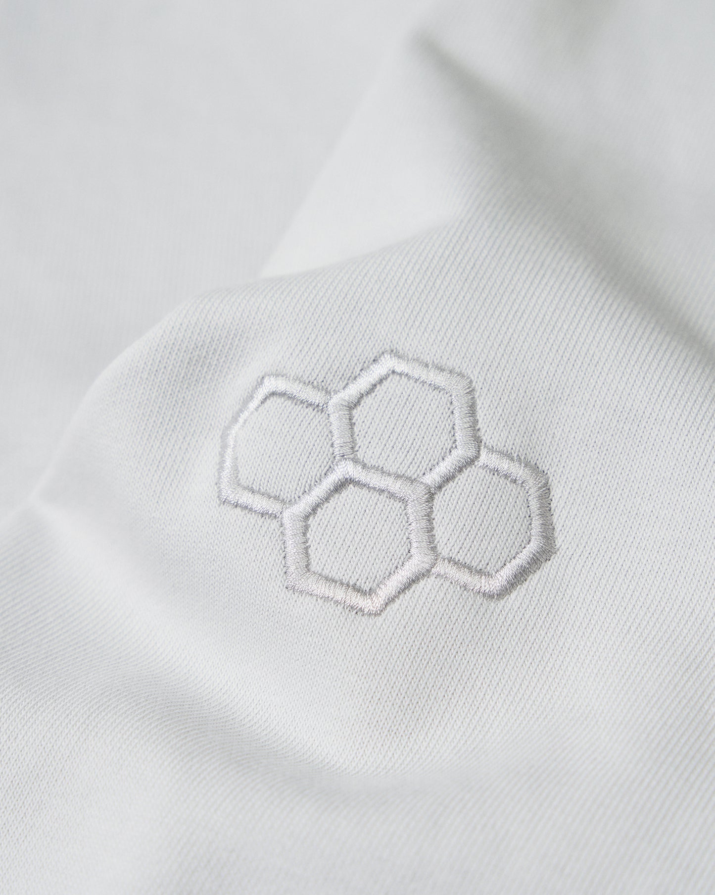 Close-up of the embroidered RUDIS hex logo on the sleeve of the Lunar Lacrosse Elite Terry Hoodie, highlighting premium craftsmanship and clean athletic styling.