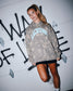 Athlete wearing the RUDIS Motto Lacrosse Tradition Hoodie in Tree Camo featuring an all-over camouflage print, oversized Lacrosse graphic with "A Way of Life" script, kangaroo pocket, and athletic streetwear styling.