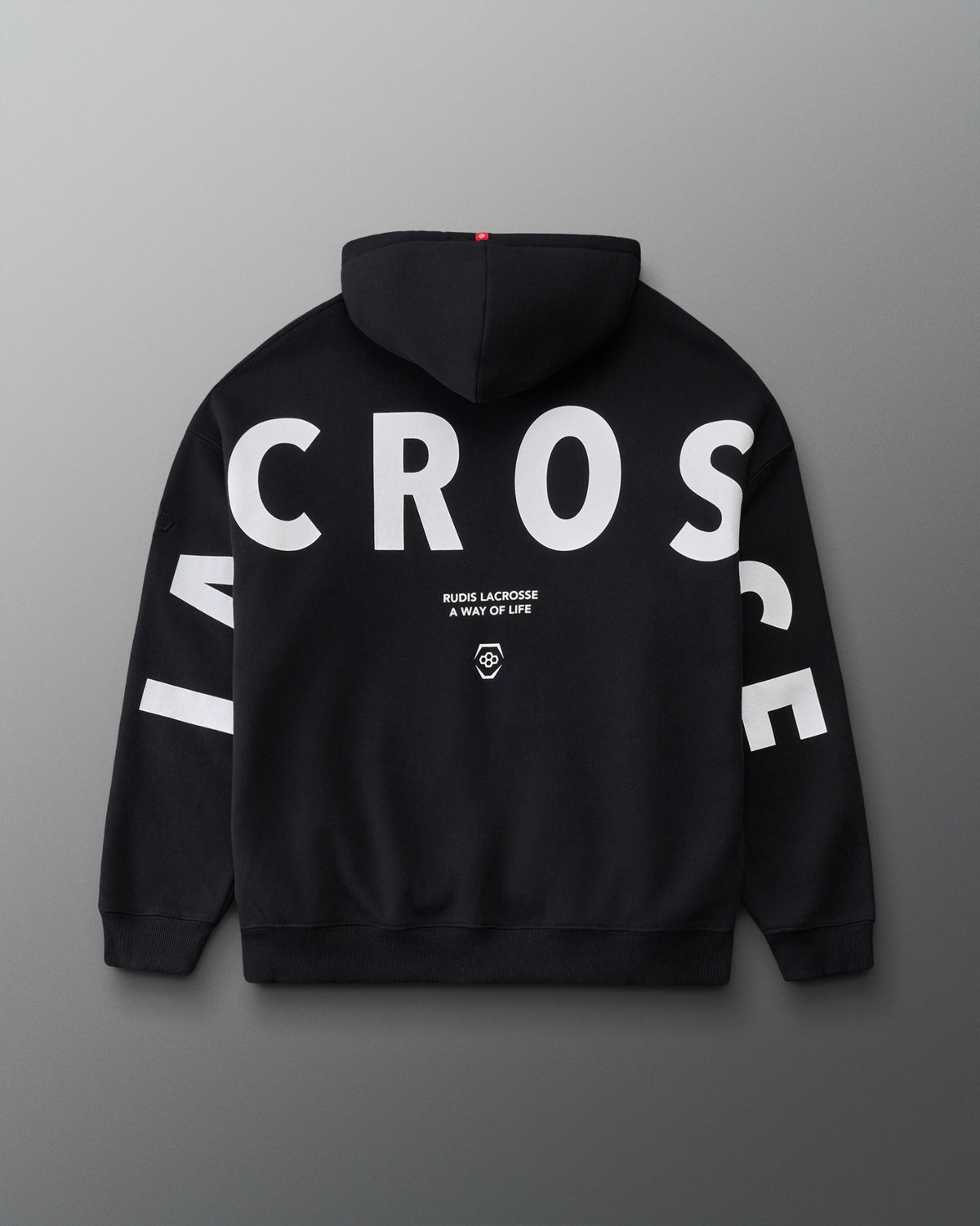 Back view of the RUDIS Lacrosse Relaxed Comfort Fleece Hoodie in Black, showcasing oversized white LACROSSE lettering across the back and sleeves with RUDIS Lacrosse A Way of Life branding.