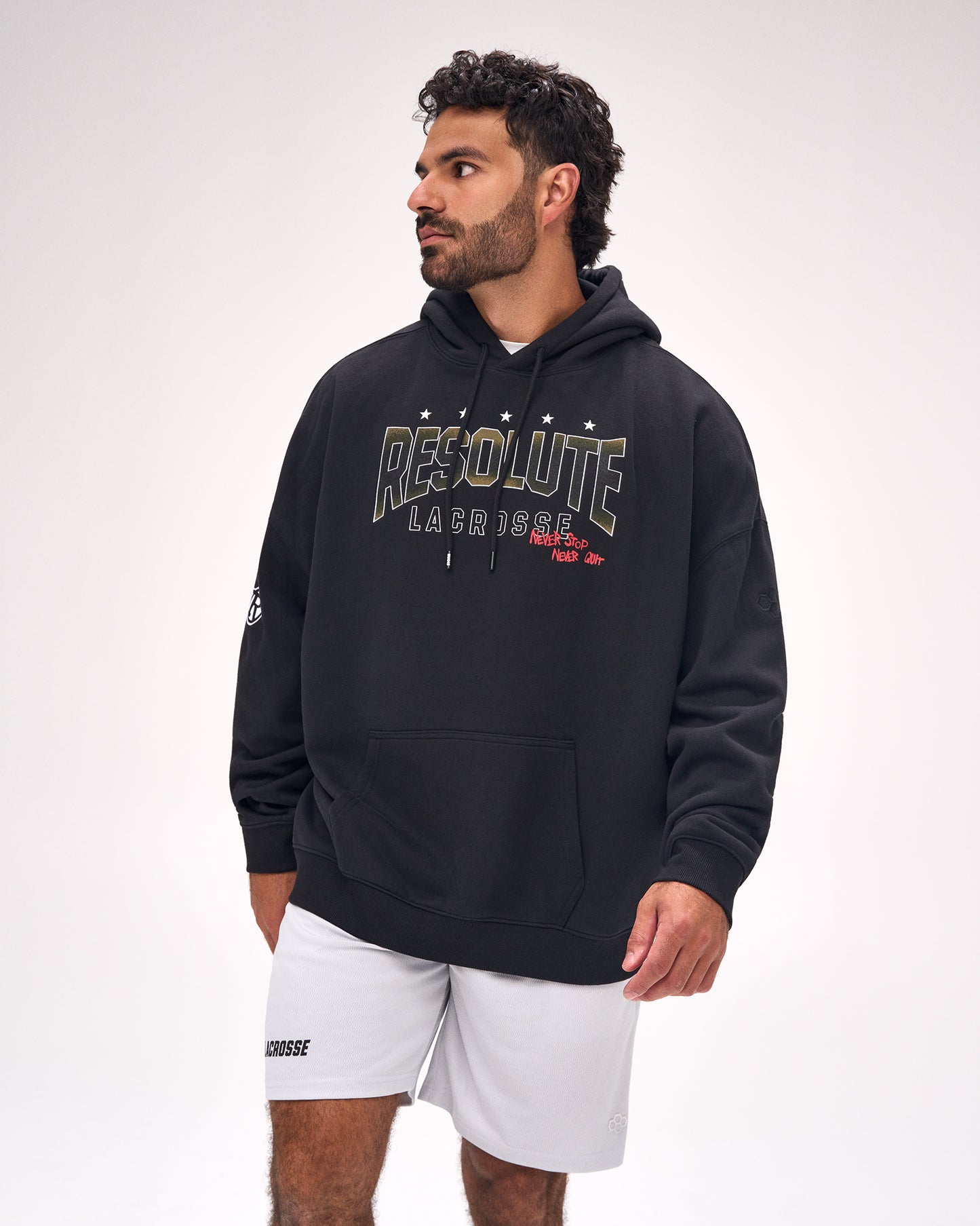 Male athlete wearing the RUDIS Resolute Lacrosse Relaxed Comfort Fleece Hoodie in Black featuring bold Resolute Lacrosse graphics and a relaxed heavyweight fit.