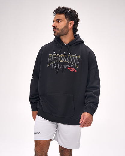 Male athlete wearing the RUDIS Resolute Lacrosse Relaxed Comfort Fleece Hoodie in Black featuring bold Resolute Lacrosse graphics and a relaxed heavyweight fit.