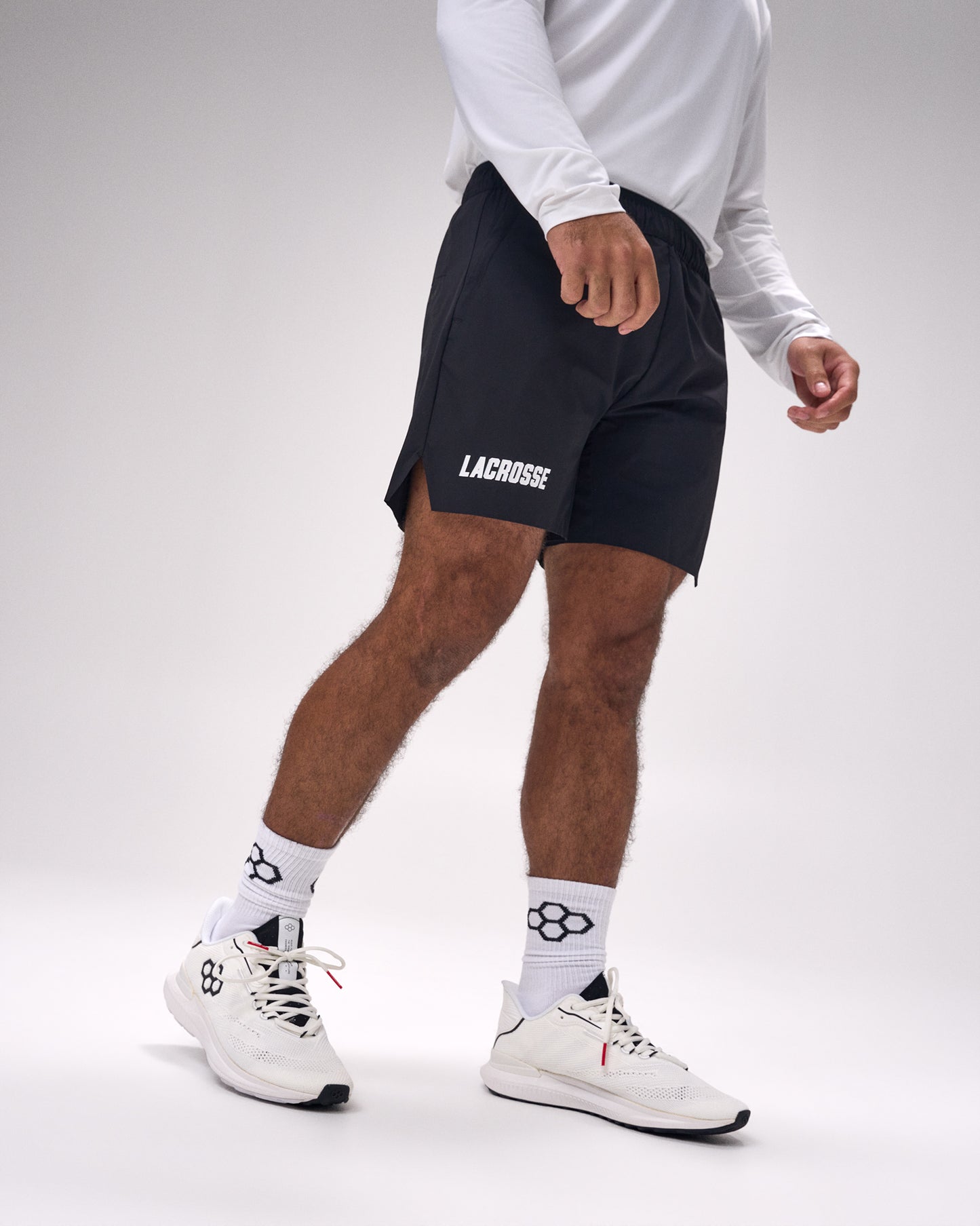 Male athlete wearing RUDIS Lacrosse Wordmark 7-Inch 2.0 Mesh Shorts in Black featuring lightweight breathable mesh fabric, athletic fit, and bold Lacrosse wordmark.