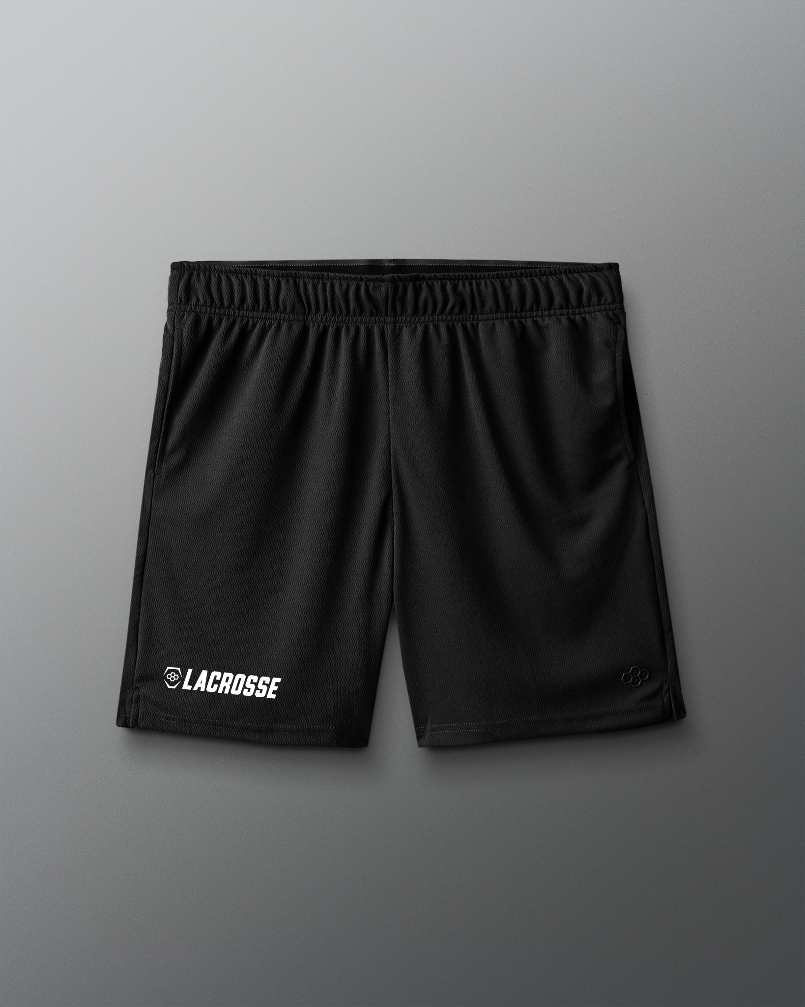 Black lacrosse shorts on a gray background