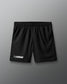 Black lacrosse shorts on a gray background