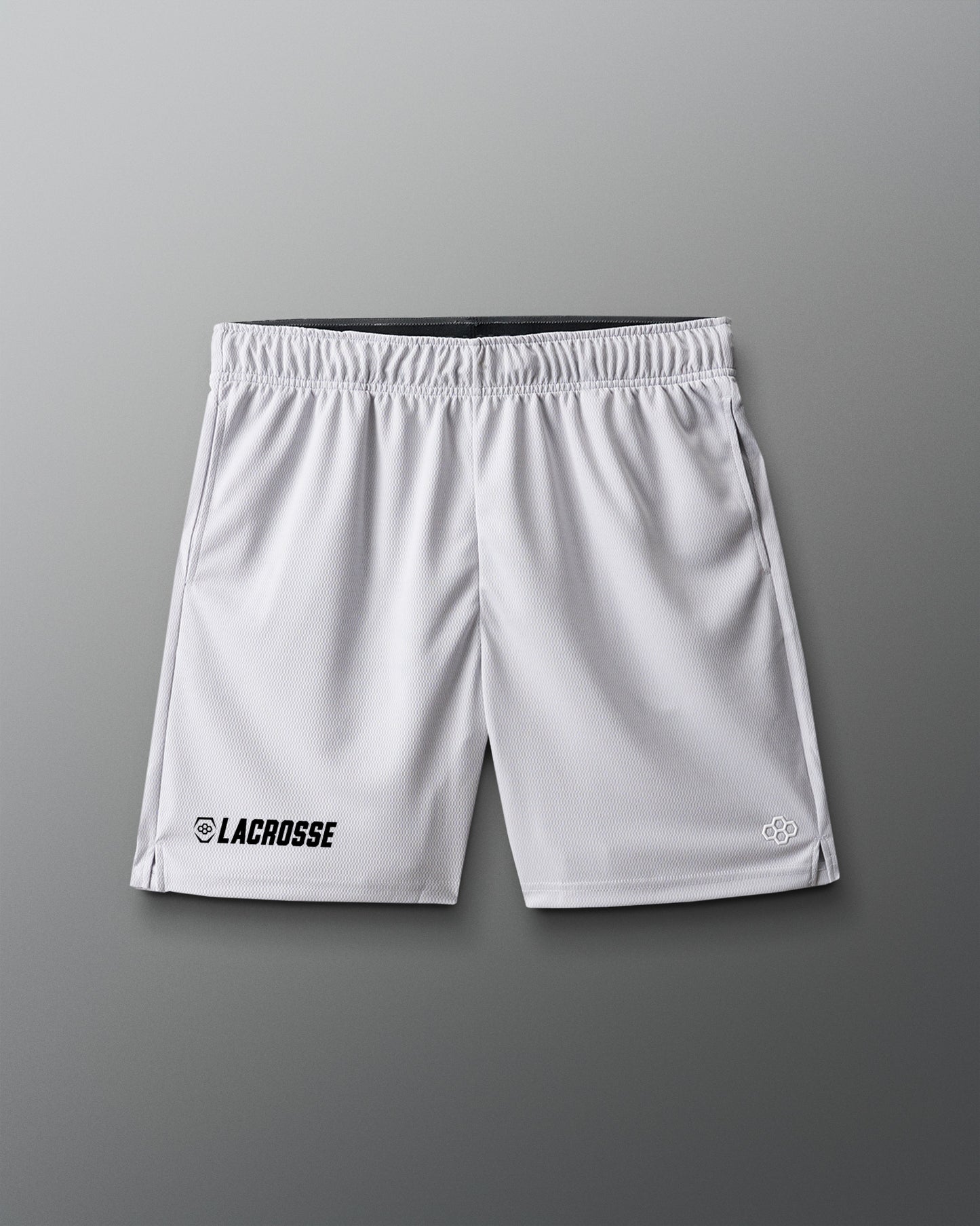 White lacrosse shorts on a gray background