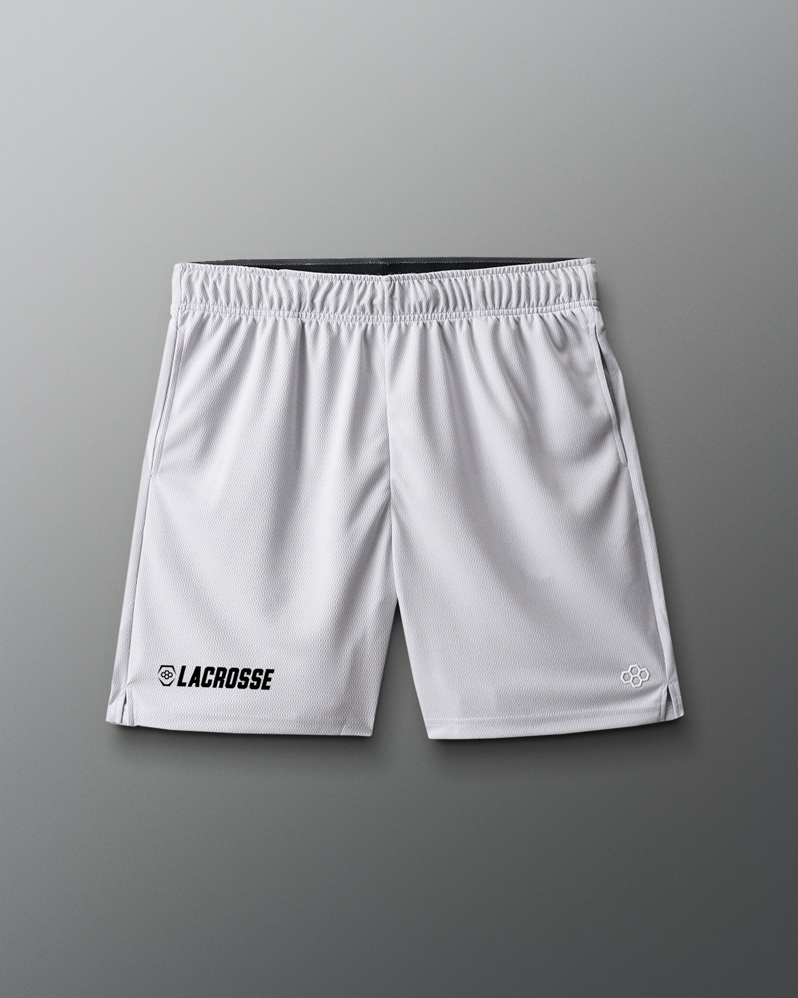 White lacrosse shorts on a gray background