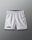 White lacrosse shorts on a gray background