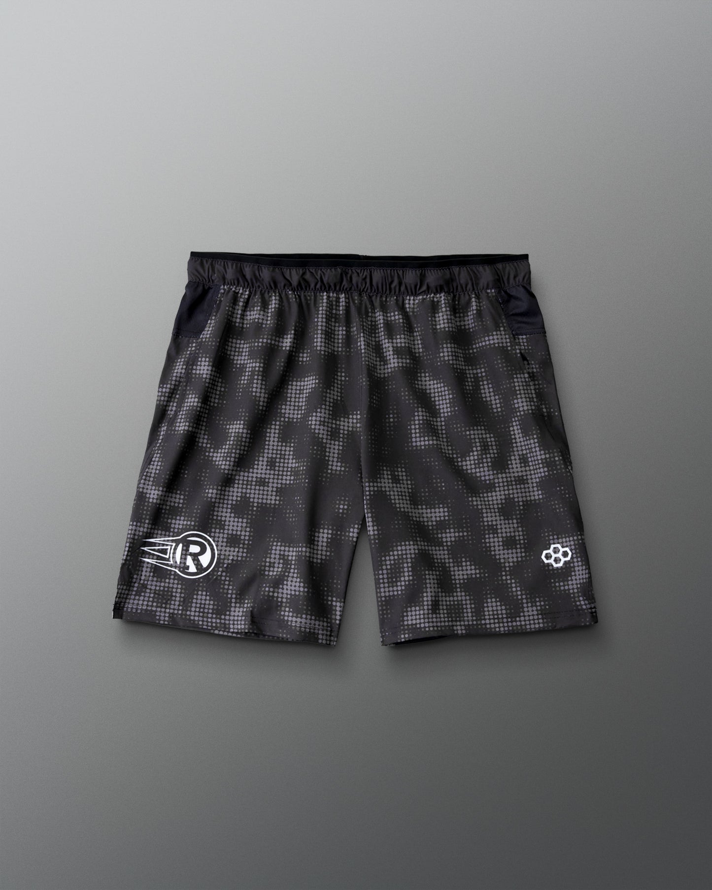 RUDIS Resolute Attack lacrosse shorts in black featuring an all-over tonal camo print, elastic waistband, side pockets, and athletic performance fit.