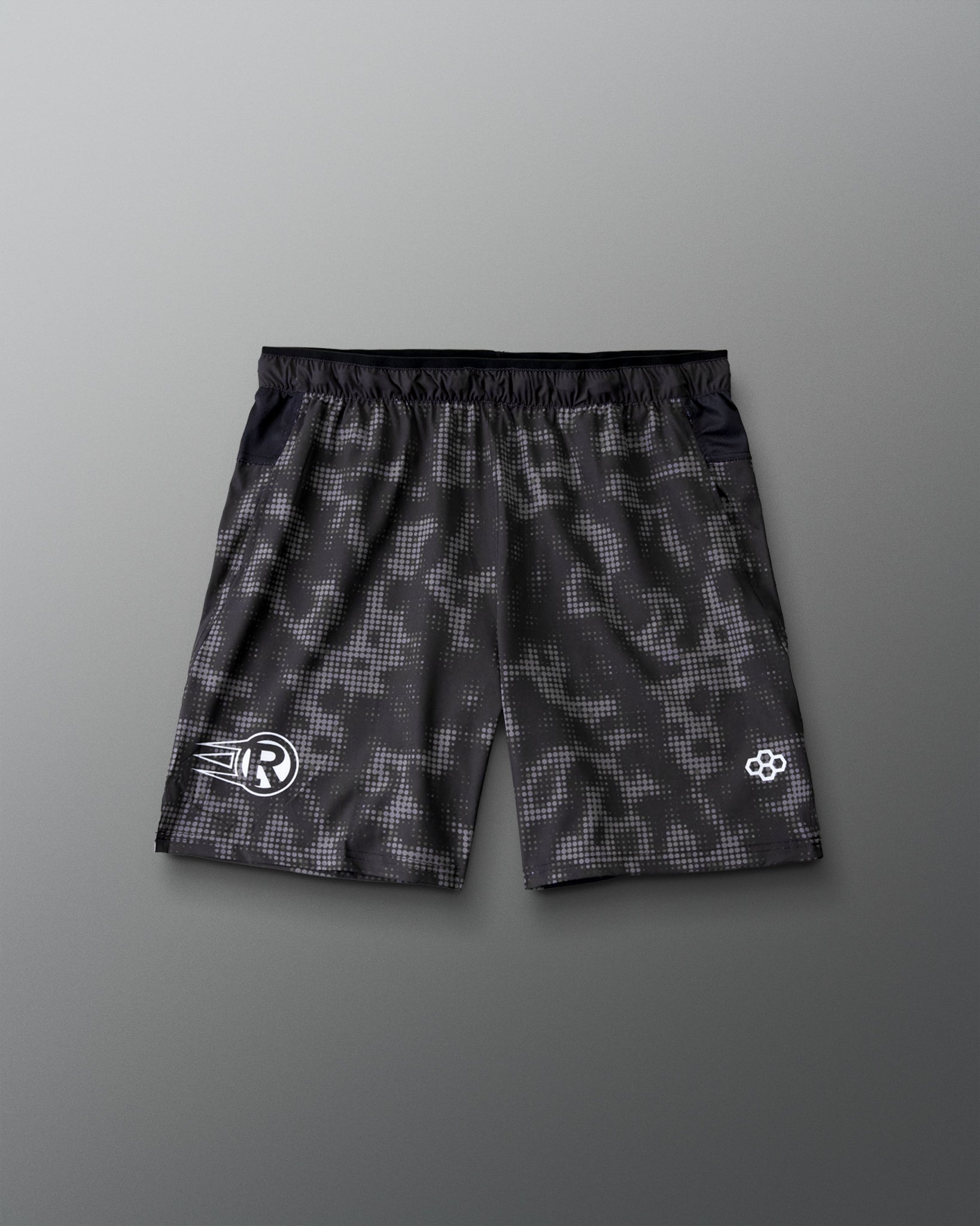 RUDIS Resolute Attack lacrosse shorts in black featuring an all-over tonal camo print, elastic waistband, side pockets, and athletic performance fit.