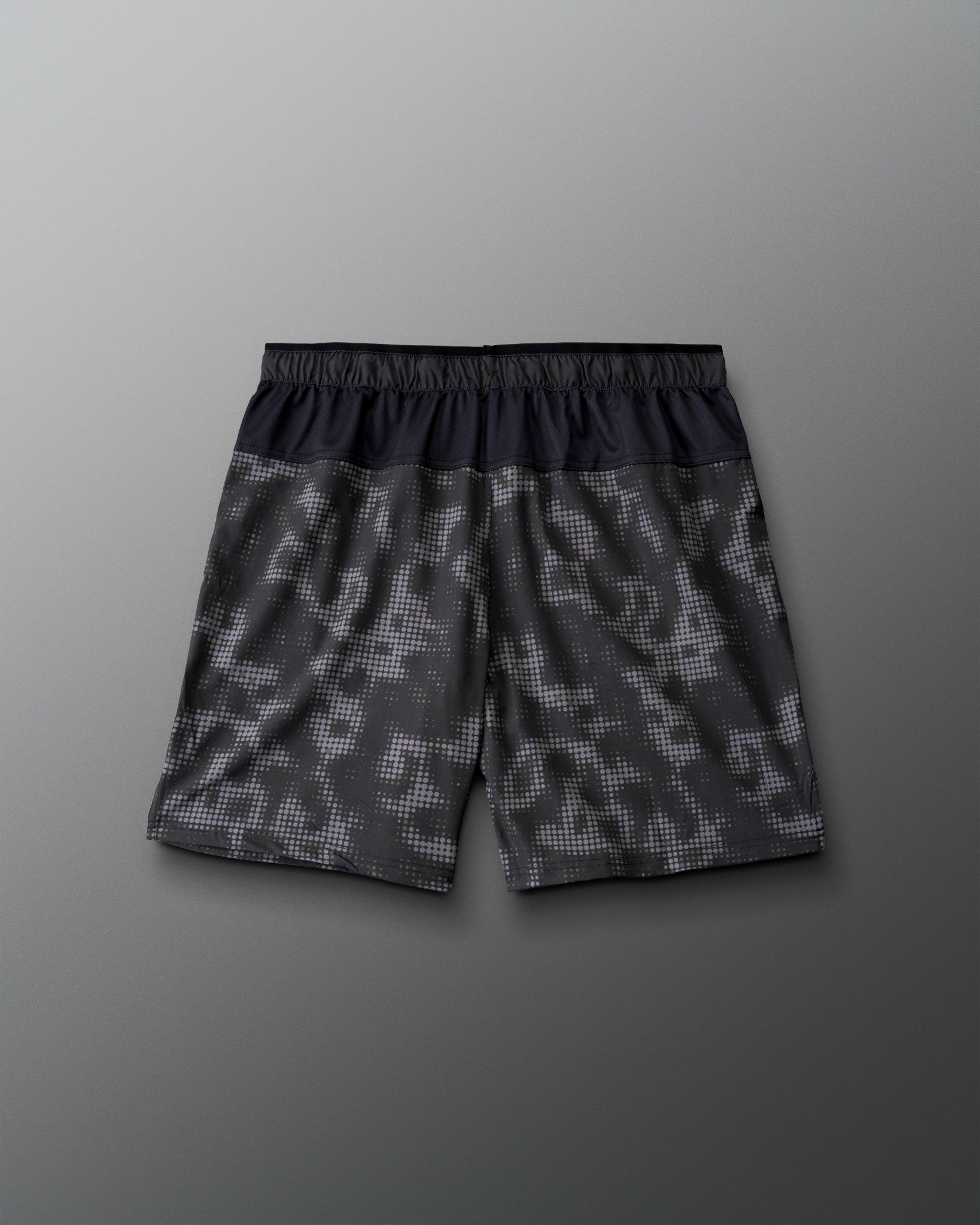 RUDIS Resolute Attack lacrosse shorts in black with a tonal camo print, featuring an elastic waistband, side pockets, Rocket logo on the left leg, and RUDIS logo on the right leg.