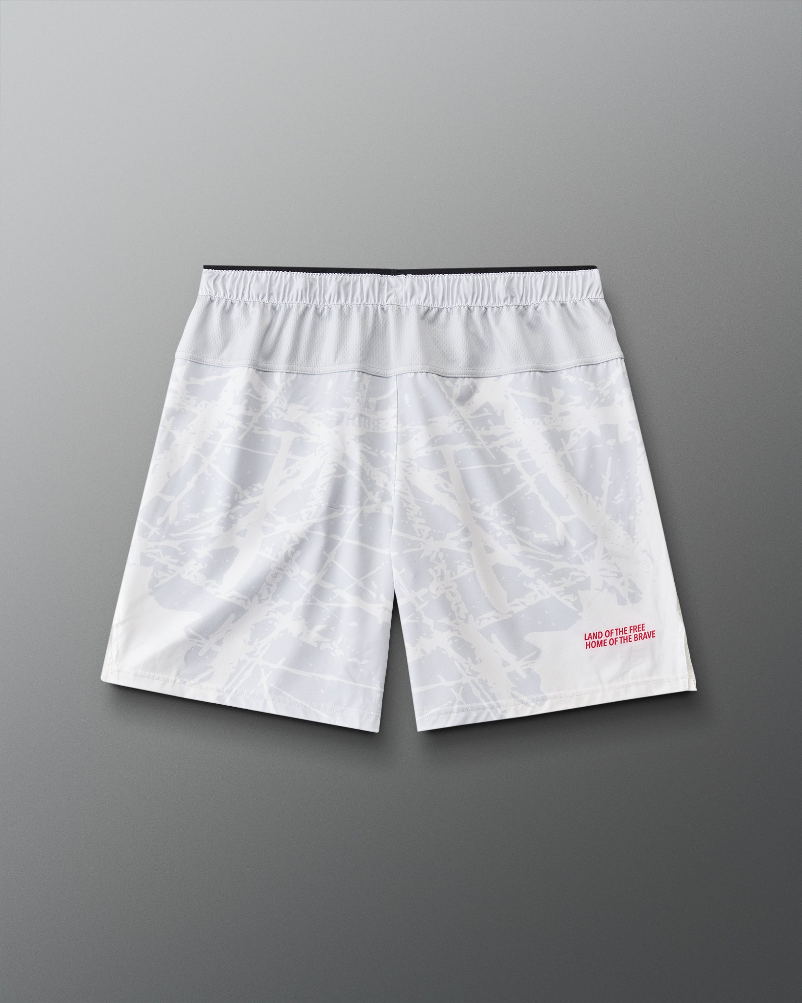 Back view of RUDIS Lacrosse Flag 7" Attack Shorts in white with tonal graphic print and “Land of the Free, Home of the Brave” detail.