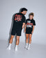 Male and female athletes wearing the RUDIS The Creator's Game Hybrid T-Shirt in black. The front features bold "The Creator's Game" artwork, while the back showcases oversized "A Way of Life" graphics inspired by lacrosse culture.