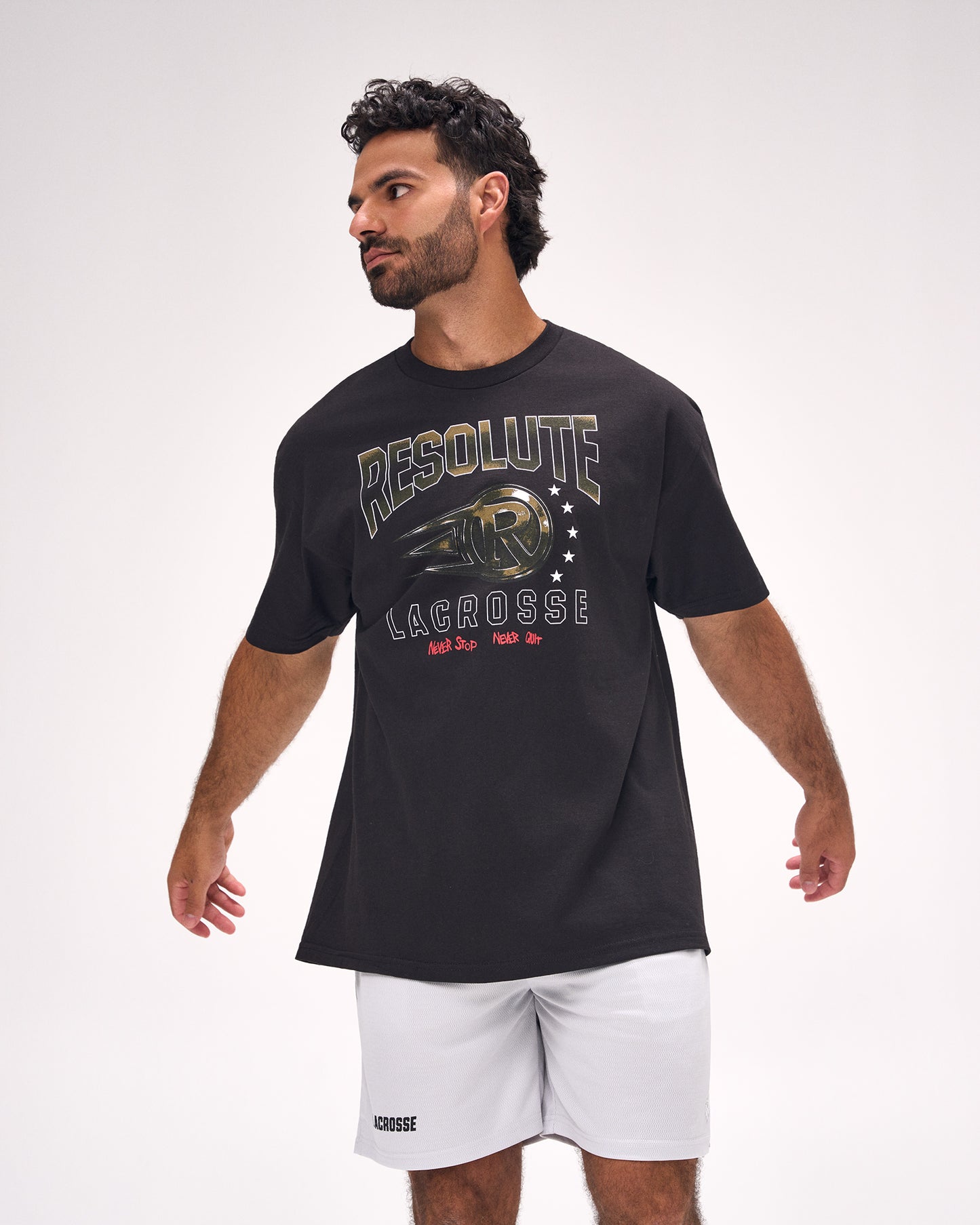 Male athlete wearing the RUDIS Resolute Lacrosse Heavyweight T-Shirt in Black featuring bold "Resolute Lacrosse" graphics, oversized heavyweight fit, and premium everyday comfort.