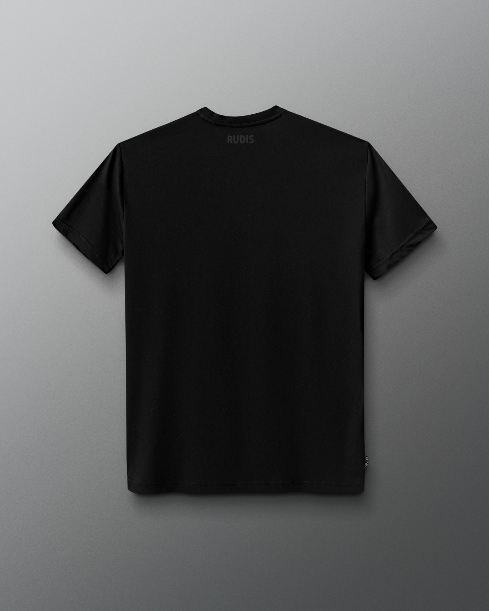 A black short-sleeve crewneck t-shirt shown from the back, featuring a small white 'RUDIS' logo printed inside the collar, displayed against a dark gray gradient background.