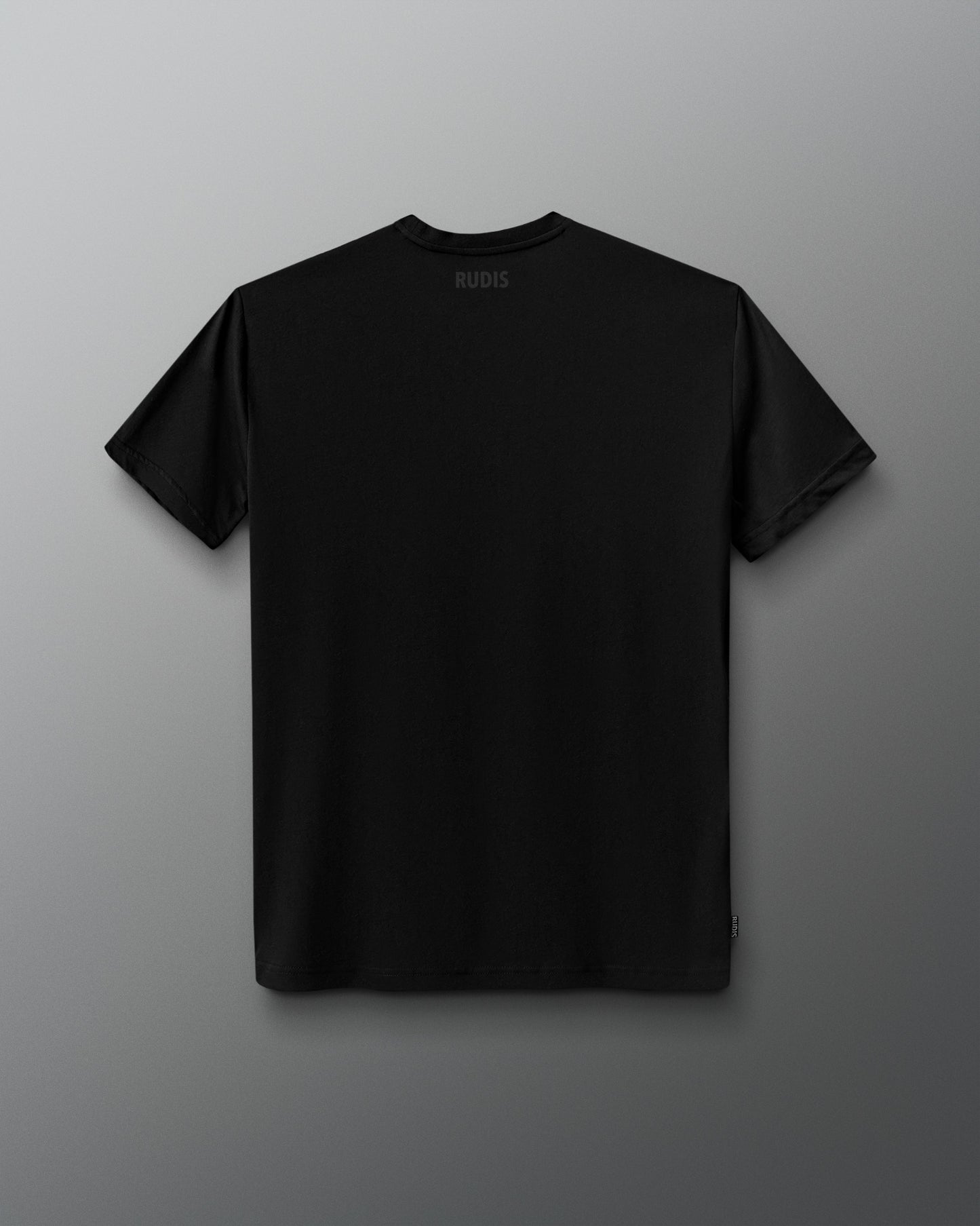 A black short-sleeve crewneck t-shirt shown from the back, featuring a small white 'RUDIS' logo printed inside the collar, displayed against a dark gray gradient background.