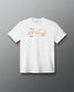 A white short-sleeve crewneck t-shirt featuring a graphic print on the chest with an orange signature and small black text, displayed against a dark gray gradient background.