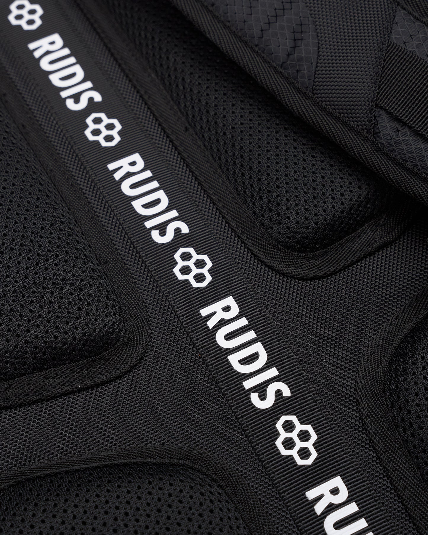 Black protective gear with 'RUDIS' branding on a black background