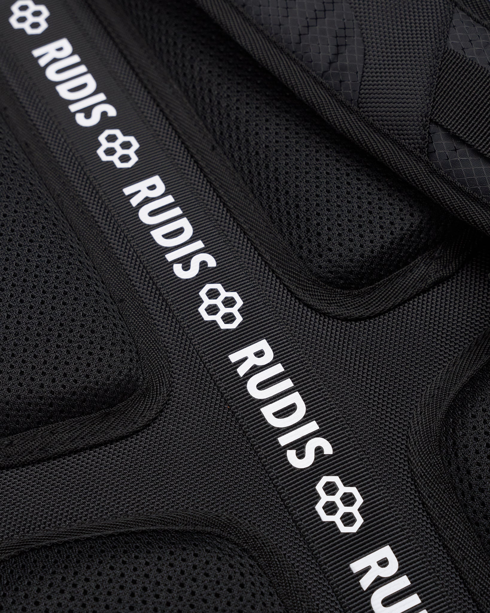 Black protective gear with 'RUDIS' branding on a black background