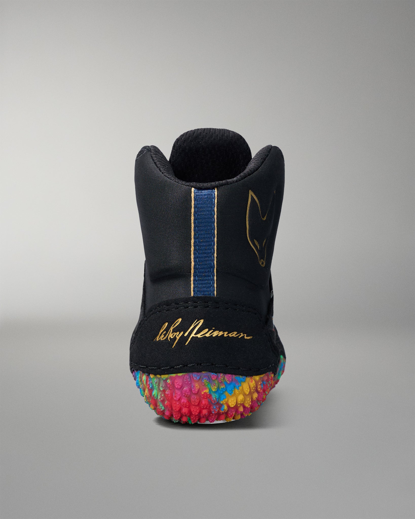 Black wrestling shoe with colorful sole and visible brand name on a gray background