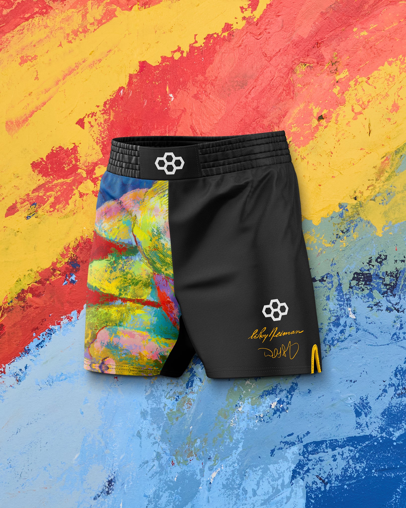 Black athletic shorts with colorful design on a multicolored abstract background