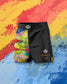Black athletic shorts with colorful design on a multicolored abstract background