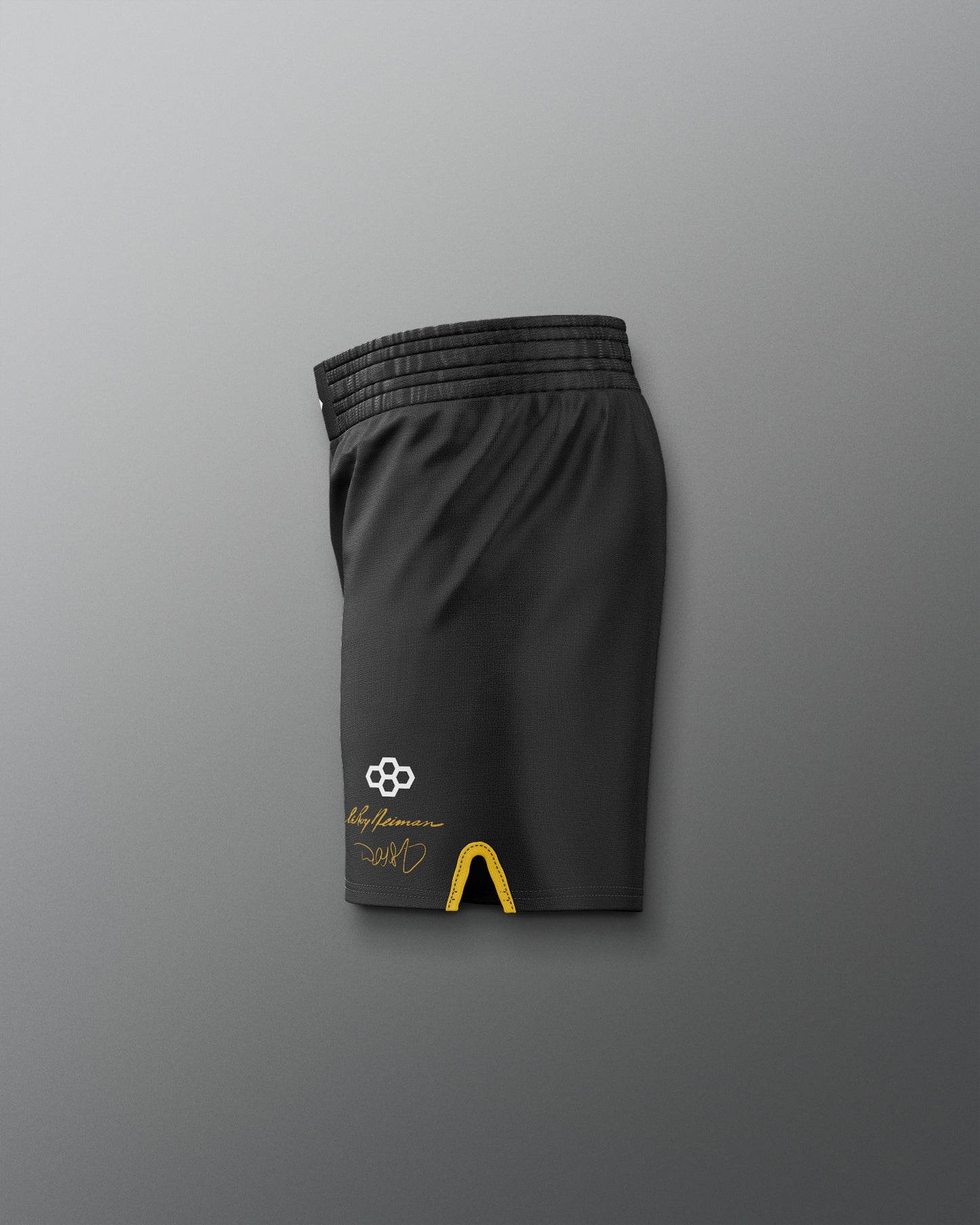 Black athletic shorts with a logo on a gray background