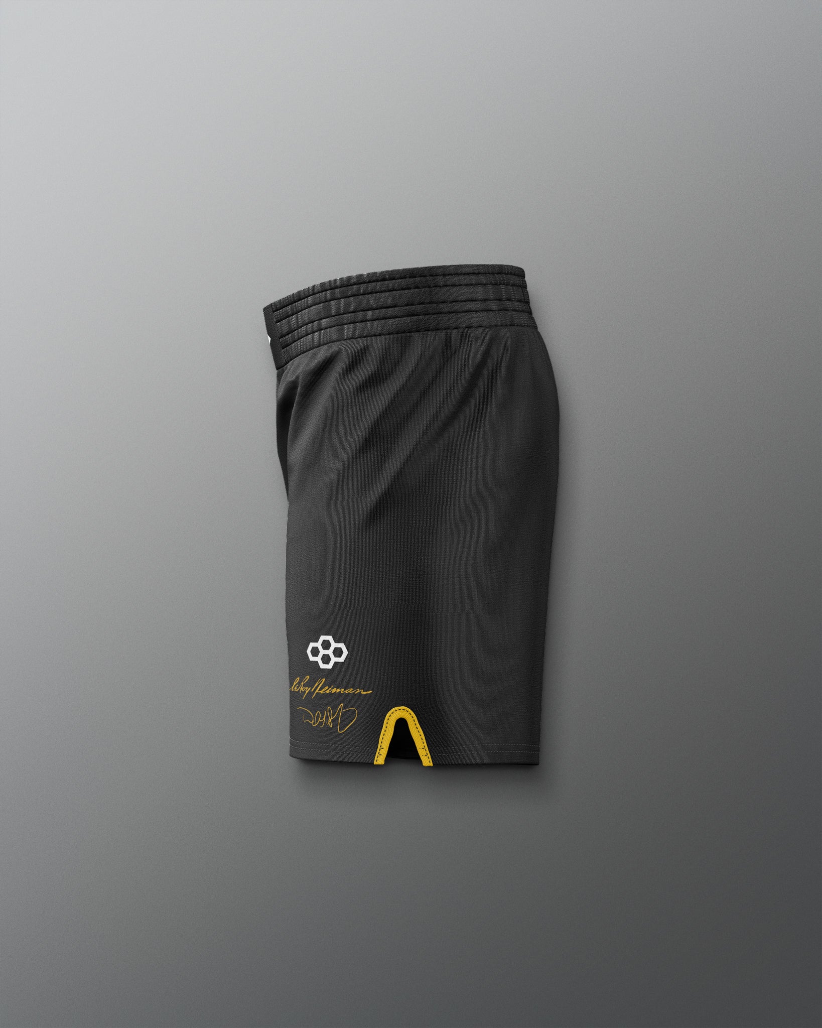 Black athletic shorts with a logo on a gray background