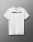 White t-shirt with text 'A Way of Life' on the back against a gray background