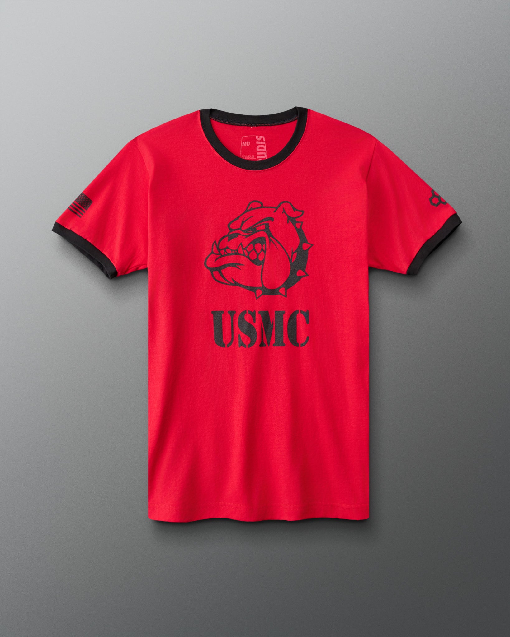 RUDIS USMC Devil Dog Ringer T-Shirt in Red/Black, front view featuring a bold black bulldog graphic above USMC lettering, contrasting black collar and sleeve cuffs, and American flag sleeve detail. 