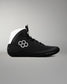 Black wrestling shoe with white accents on a gray background