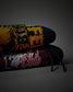 Two rolled black hoodies stacked on a dark gray studio background. The top hoodie has a yellow and black graphic design, and the bottom hoodie is black with red and white flame patterns and the text 'HOWARD of Ohio'.