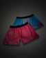 Two pairs of athletic shorts from the brand RUDIS, displayed against a dark gray gradient background. The front pair is a vibrant pink-to-red gradient with a black waistband, and the back pair is a blue-to-purple gradient with a black waistband.