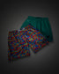 Two pairs of athletic shorts displayed together on a dark gray background. The front pair features a vibrant multicolor camouflage pattern in red, blue, yellow, and green, while the back pair is a solid teal green with a small black logo on the side.