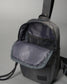 Gray backpack with an opened front pocket revealing a soft interior displaying 'RUDIS' branding, designed for modern functionality.