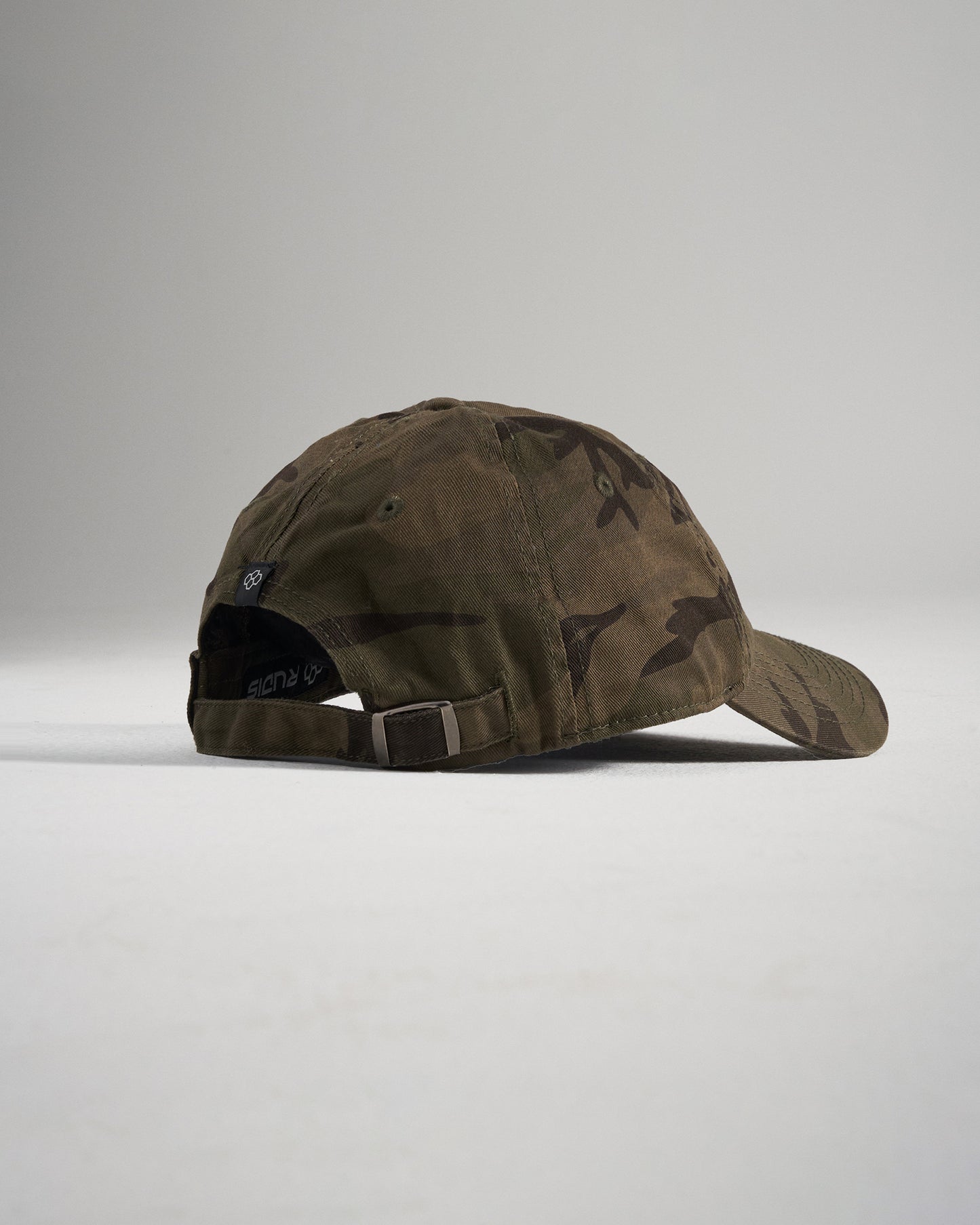 A stylish olive green camouflage cap featuring an adjustable strap and a relaxed fit design ideal for casual wear or outdoor activities