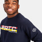 A young man with a joyful expression wearing a navy blue sweatshirt featuring PRTC WRESTLING graphics in bold colors across the chest