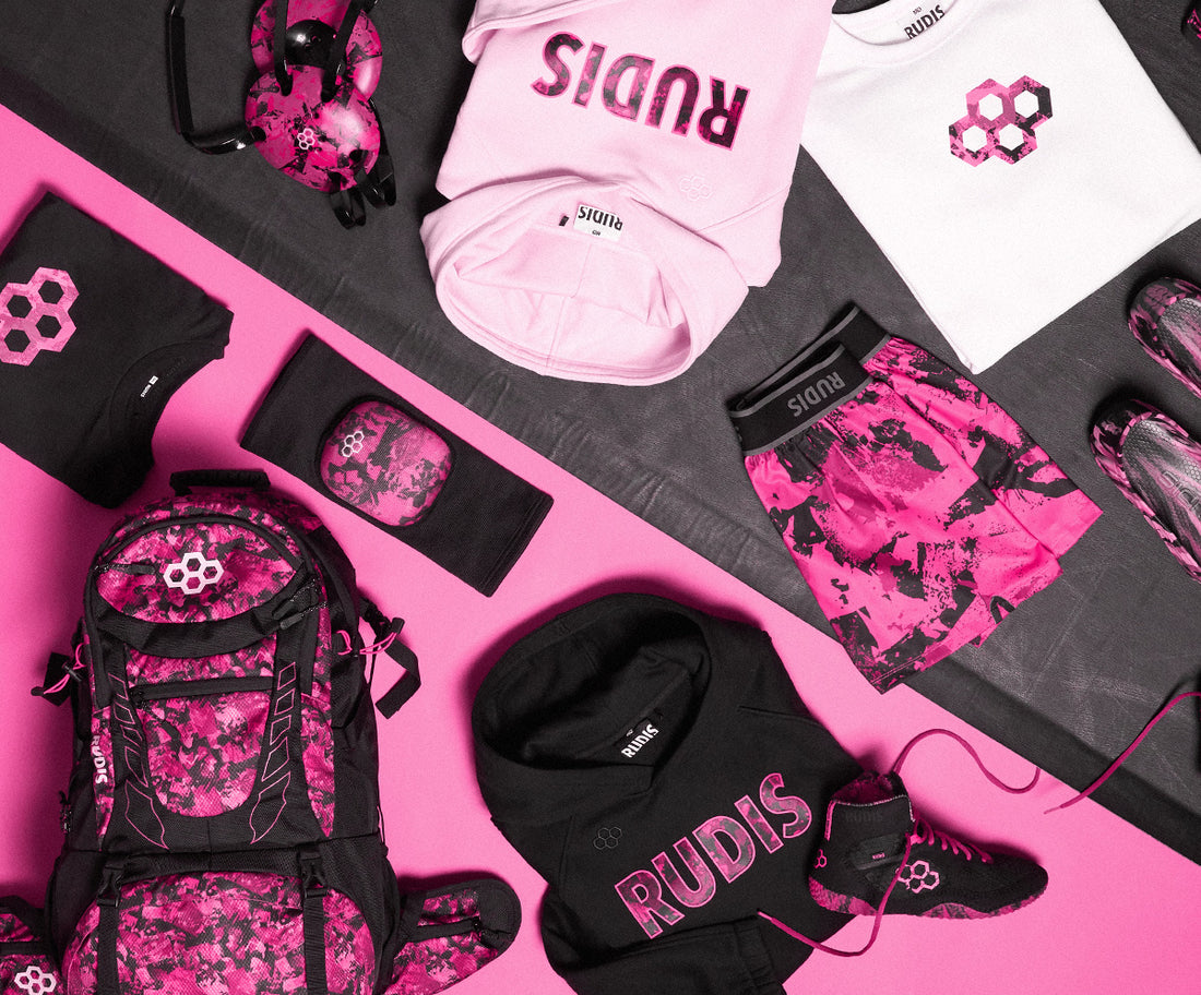 The RUDIS Pink Power Collection featuring bold pink and black wrestling gear including backpacks, wrestling shoes, apparel, headgear, knee pads, and shorts – designed for wrestlers who want style and performance on and off the mat.