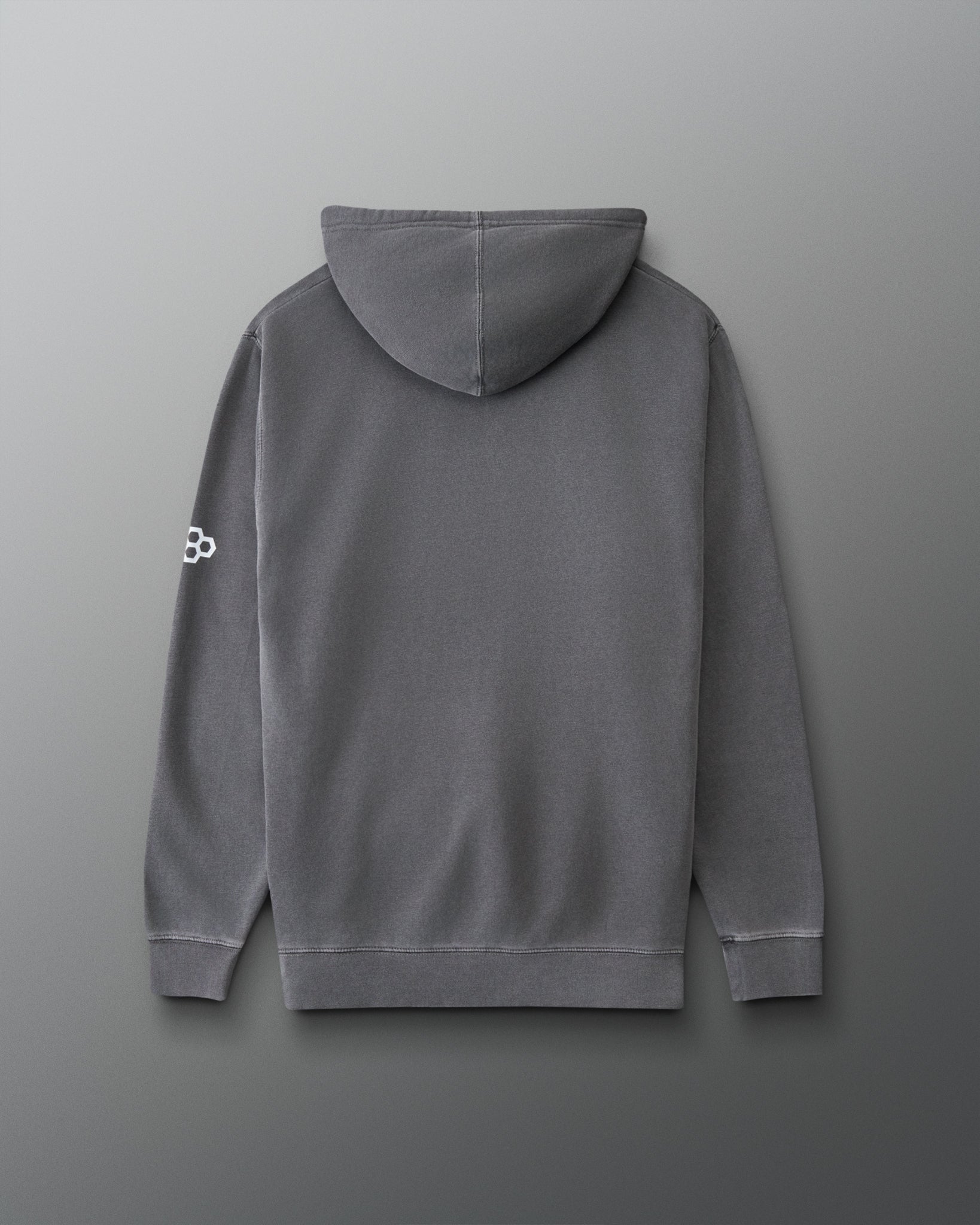 A dark gray pullover hoodie shown from the back, featuring a small white geometric logo on the left sleeve, set against a dark gray gradient background.