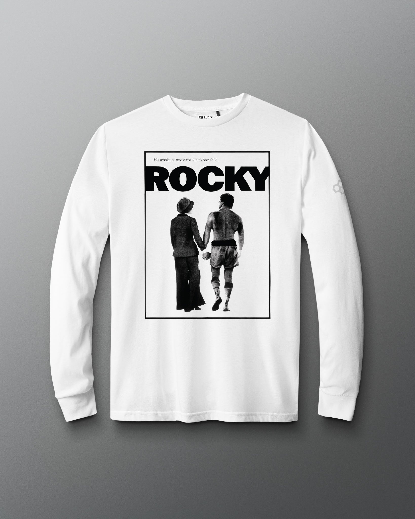 A white long-sleeve t-shirt with a black graphic print of the Rocky movie poster on the front, displayed against a neutral gray background.