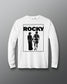 A white long-sleeve t-shirt with a black graphic print of the Rocky movie poster on the front, displayed against a neutral gray background.