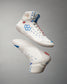 A pair of stylish white high-top shoes with blue and red accents featuring a unique honeycomb pattern and a bold design for athletic performance