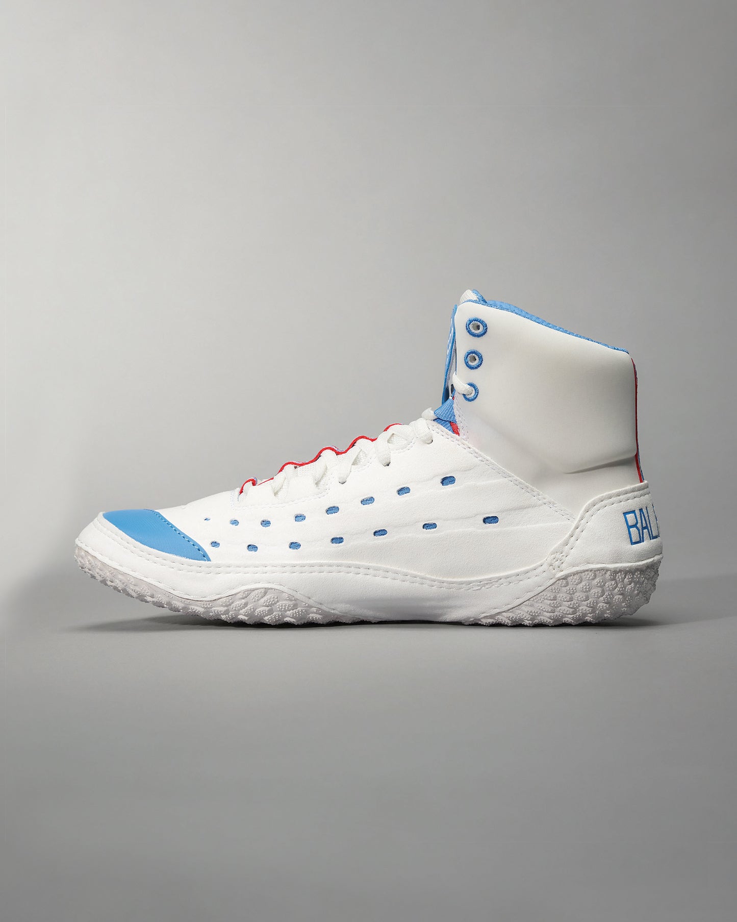 A modern white sneaker featuring blue accents red laces and a textured sole designed for performance and style
